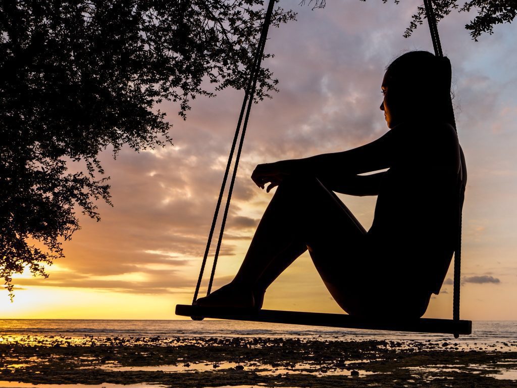 girl reflecting spiritual reality at sunset
